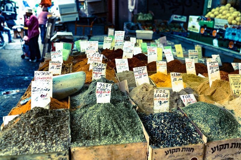 Sacks and boxes of spices with price tags at the Carmel Market