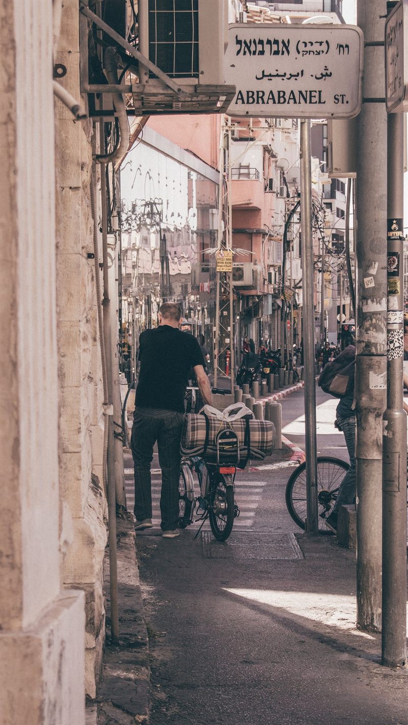 A man with a bicycle on Abarbanel Street in Florentin, Tel Aviv