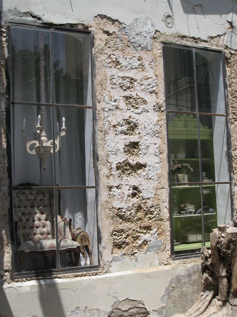 An old stone house with tall shop windows in Neve Tzedek