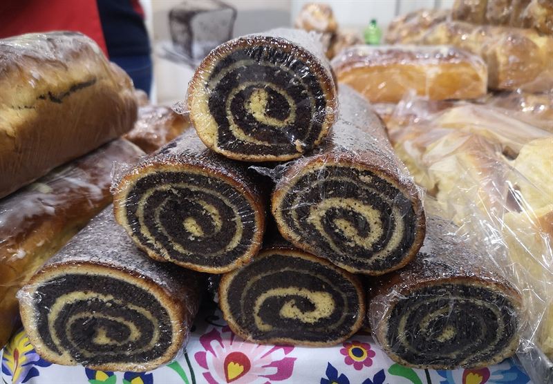 Poppy seed rolls stacked on a market table